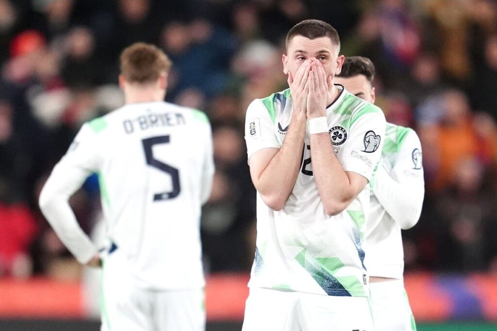 Dejected Republic of Ireland players on the pitch after losing a penalty shootout to the Czech Republic.