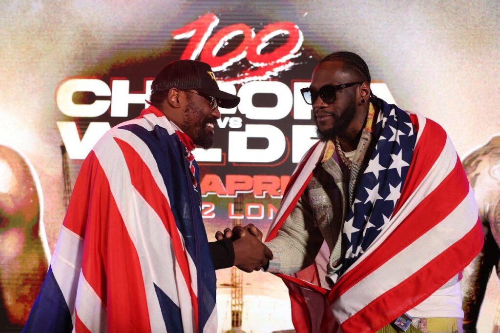 Derek Chisora and Deontay Wilder facing off in a boxing ring ahead of their heavyweight clash