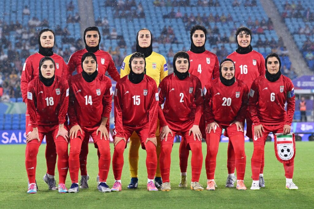 Iran women's football team lining up on the pitch before an international match