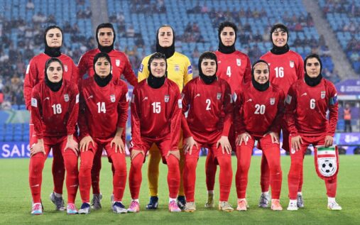 Iran women's football team lining up on the pitch before an international match