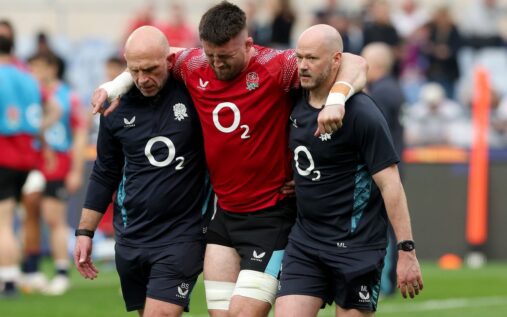 England flanker Tom Curry being helped off the pitch by medical staff during the warm-up
