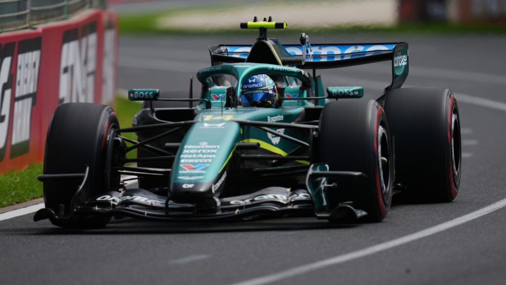 Fernando Alonso driving the Aston Martin Formula 1 car on track