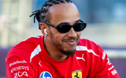Ferrari team principal Frederic Vasseur and driver Lewis Hamilton walking together in the Formula 1 paddock