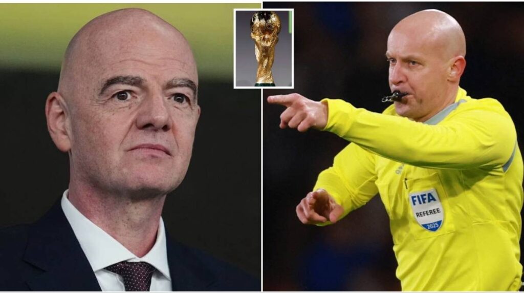 A football referee signalling towards the pitch during an international match