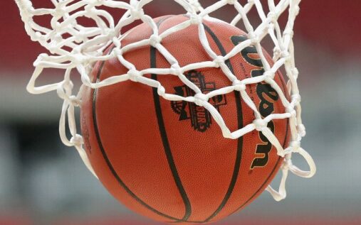 A generic view of a collegiate basketball court and a wooden gavel representing the federal betting scandal