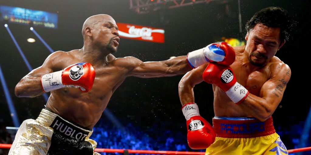 Floyd Mayweather and Manny Pacquiao face off in a boxing ring during their 2015 bout