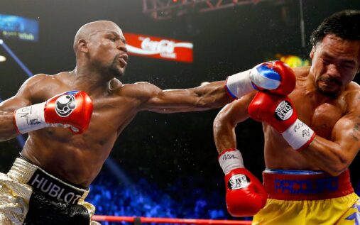 Floyd Mayweather and Manny Pacquiao face off in a boxing ring during their 2015 bout