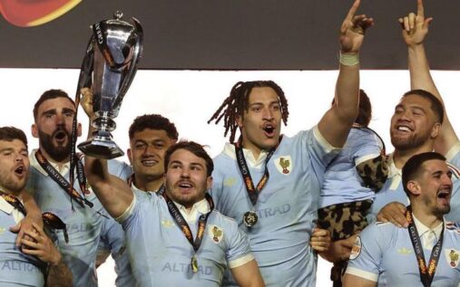 Antoine Dupont lifting the Six Nations trophy for France surrounded by fireworks at the Stade de France