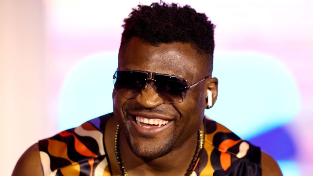 Francis Ngannou posing with his fists raised during a mixed martial arts weigh-in