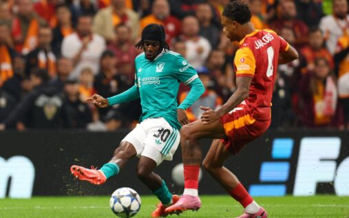 Galatasaray fans holding up scarves and lighting flares in the stands during a European match