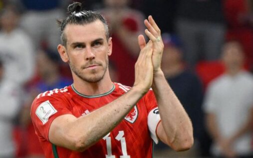 Gareth Bale applauding fans while wearing the Wales national team kit
