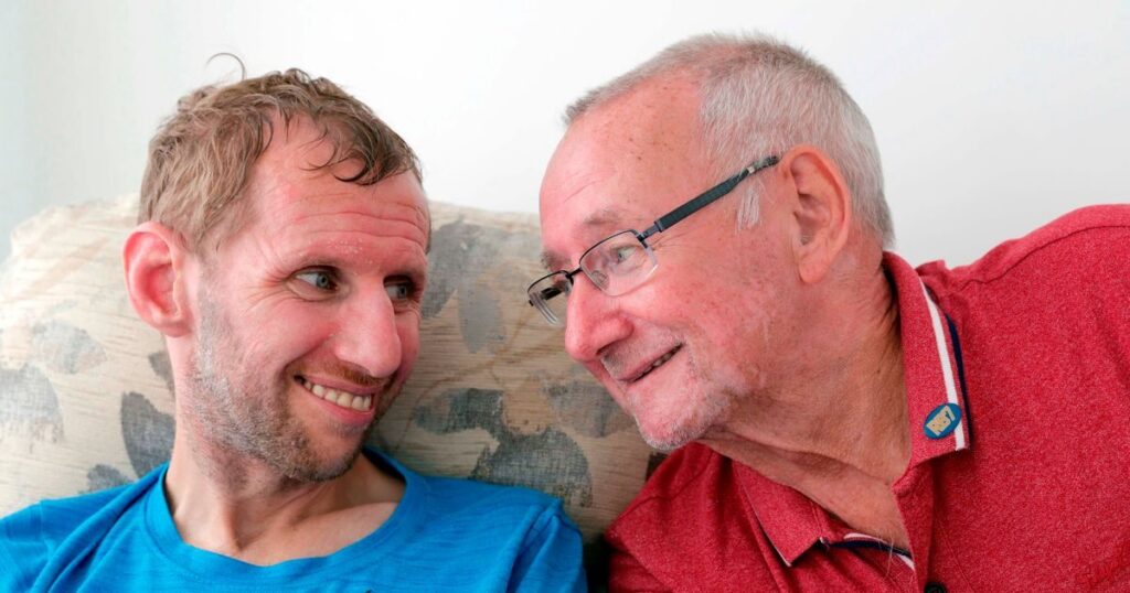 Geoff Burrow and his son Rob Burrow smiling together at a Leeds Rhinos rugby league match