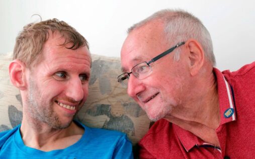 Geoff Burrow and his son Rob Burrow smiling together at a Leeds Rhinos rugby league match