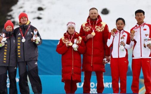 German cross-country skiers Linn Kazmaier and Florian Baumann turning their backs on Russian athletes on the podium