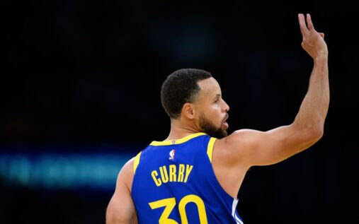 Stephen Curry of the Golden State Warriors looking on from the sidelines