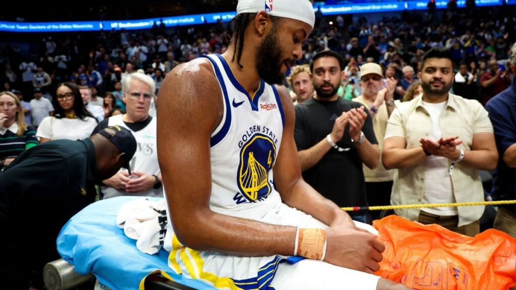 Golden State Warriors medical staff tending to an injured Moses Moody on the court