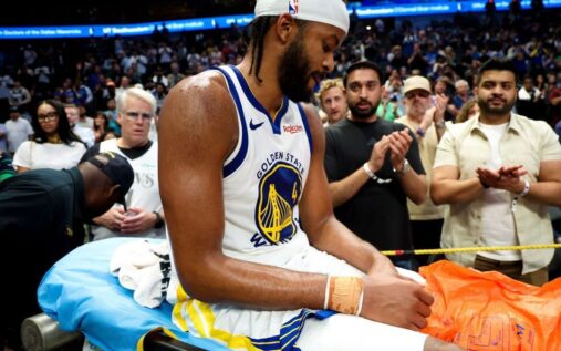 Golden State Warriors medical staff tending to an injured Moses Moody on the court