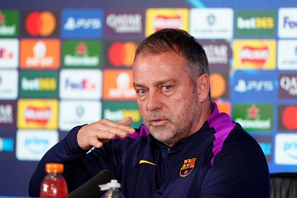 Hansi Flick looking thoughtful on the touchline while managing Barcelona