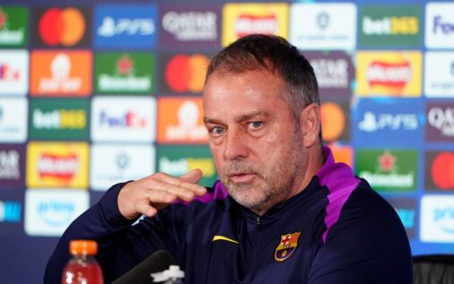 Hansi Flick looking thoughtful on the touchline while managing Barcelona