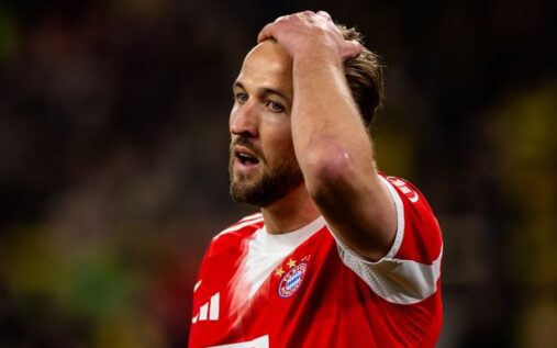 Harry Kane applauding fans while wearing the Bayern Munich kit during a Bundesliga match