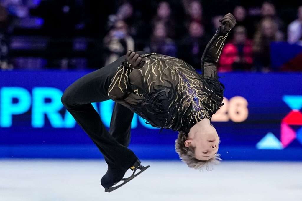 Ilia Malinin celebrating on the ice after his gold medal-winning free skate routine at the World Championships
