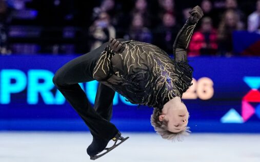 Ilia Malinin celebrating on the ice after his gold medal-winning free skate routine at the World Championships