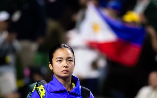 Alex Eala celebrating a victory on a hard court tennis stadium at Indian Wells surrounded by fans