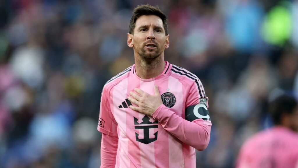 Lionel Messi applauding fans while wearing the pink Inter Miami home kit