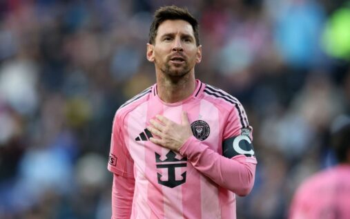 Lionel Messi applauding fans while wearing the pink Inter Miami home kit