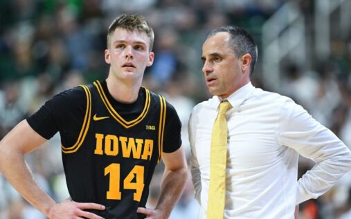 Iowa Hawkeyes coach Ben McCollum and guard Bennett Stirtz celebrating on the basketball court