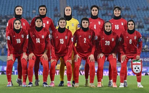 The Iran women's football team lining up on the pitch before a match at the Asian Cup in Australia