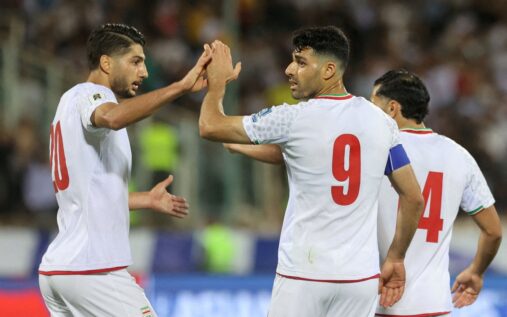 Iranian national football team players lining up on the pitch before a match