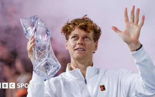Jannik Sinner holding the Miami Open trophy and celebrating his victory