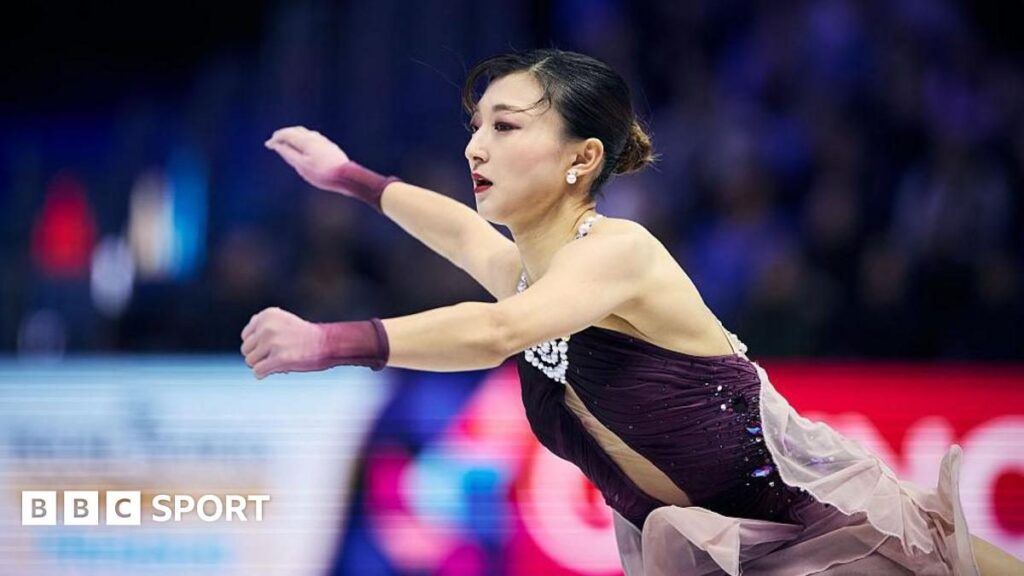Kaori Sakamoto waving to the crowd after her gold medal performance at the World Figure Skating Championships