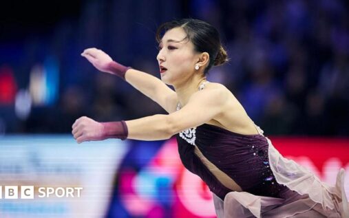 Kaori Sakamoto waving to the crowd after her gold medal performance at the World Figure Skating Championships