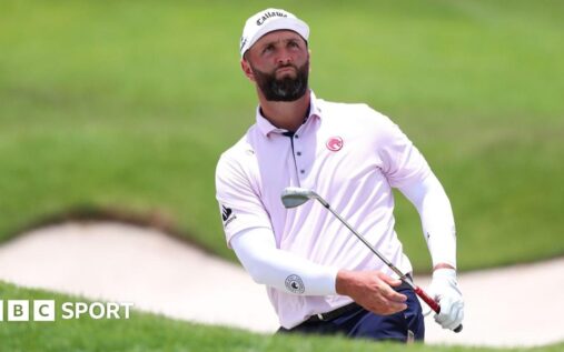 Jon Rahm looking contemplative on the golf course during a DP World Tour tournament
