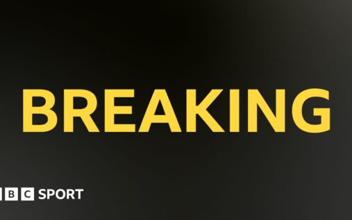 Josh Kerr celebrating as he crosses the finish line to win the world indoor 3,000m title