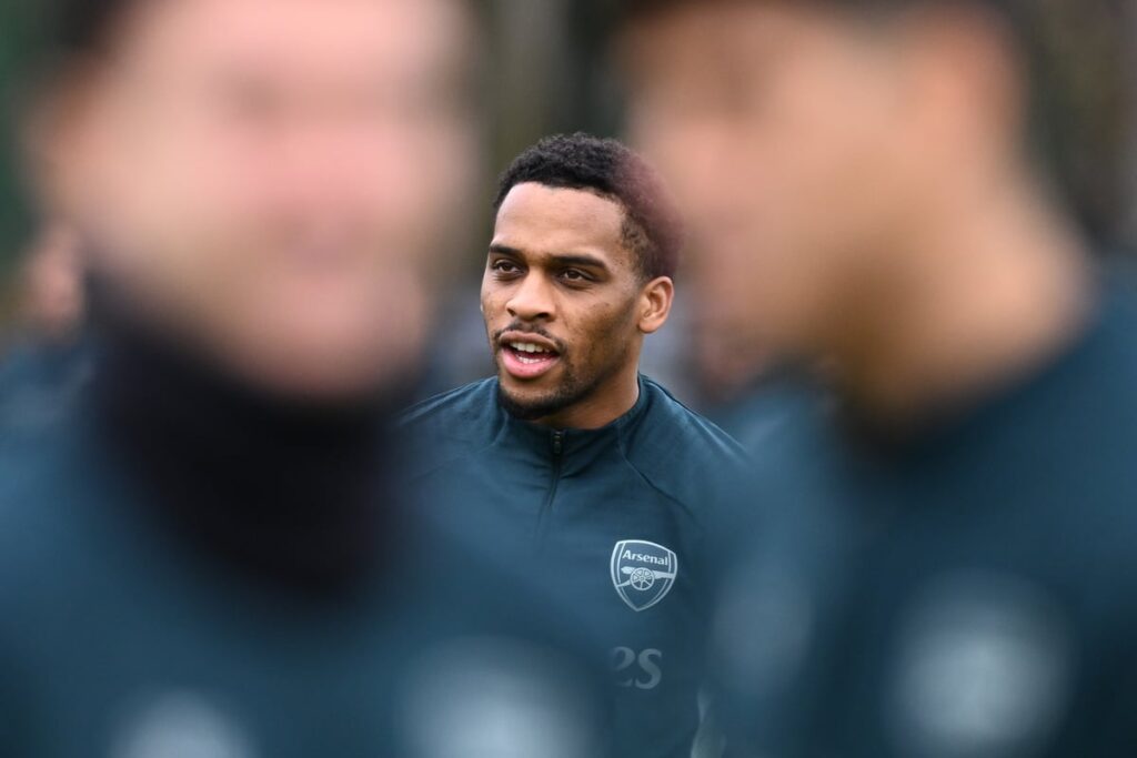 Arsenal defender Jurrien Timber gesturing on the pitch during a Premier League match