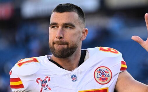Travis Kelce celebrating in a Kansas City Chiefs uniform on the field