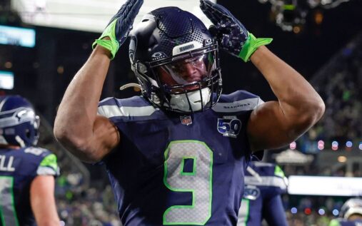 Kenneth Walker III carrying the football during a game