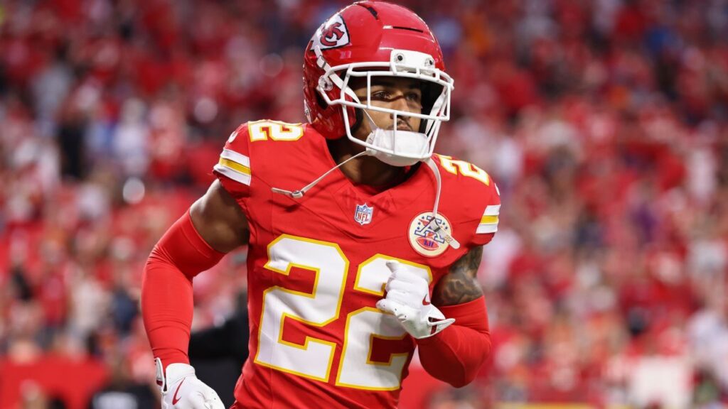 Trent McDuffie gesturing to the crowd while wearing a Kansas City Chiefs uniform