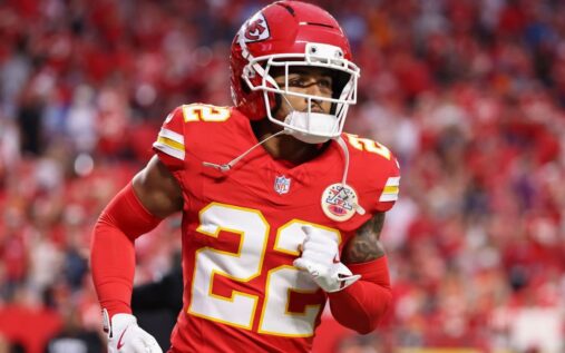 Trent McDuffie gesturing to the crowd while wearing a Kansas City Chiefs uniform