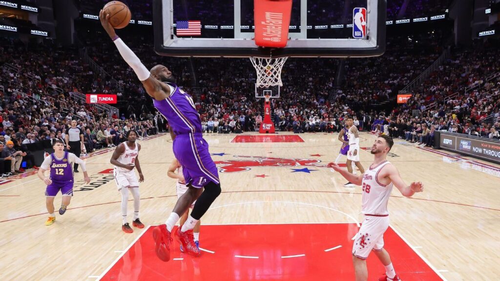 LeBron James completing a spectacular slam dunk for the Los Angeles Lakers against the Houston Rockets