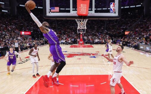 LeBron James completing a spectacular slam dunk for the Los Angeles Lakers against the Houston Rockets