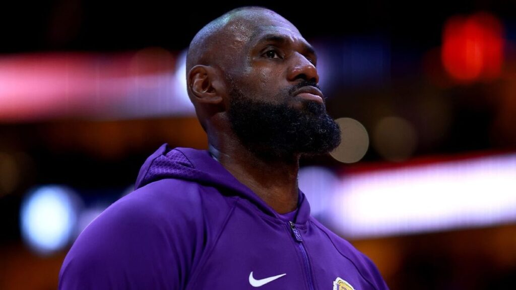 LeBron James in a Los Angeles Lakers jersey looking thoughtful on the basketball court