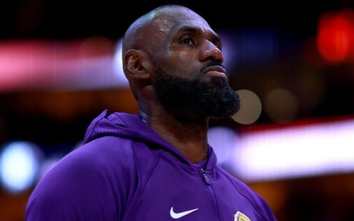 LeBron James in a Los Angeles Lakers jersey looking thoughtful on the basketball court