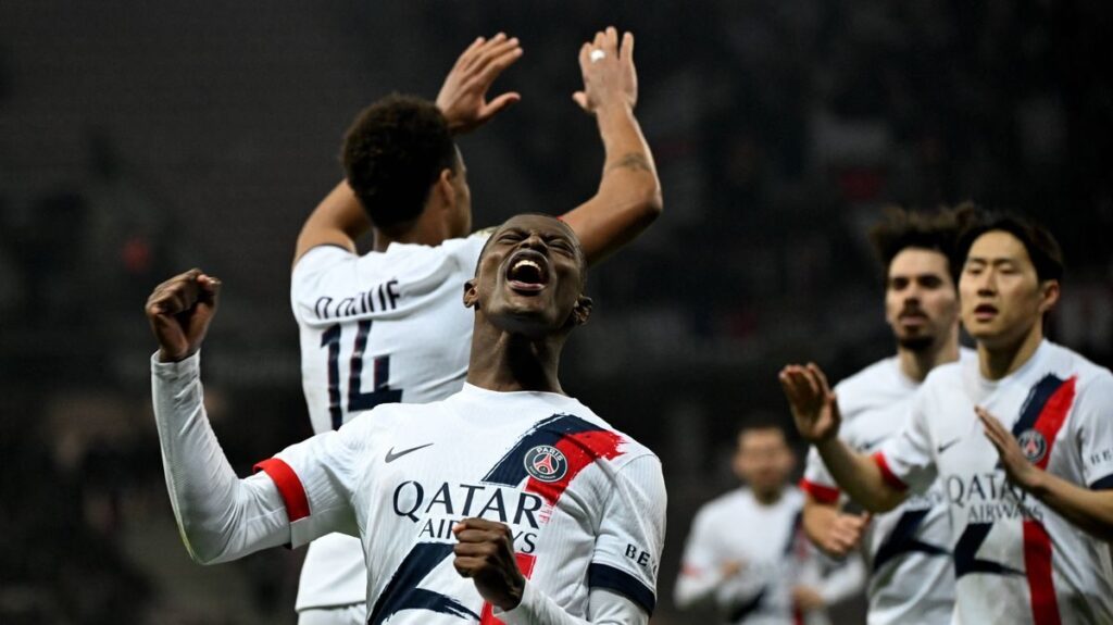 RC Lens and Paris Saint-Germain players competing on the pitch during a Ligue 1 match