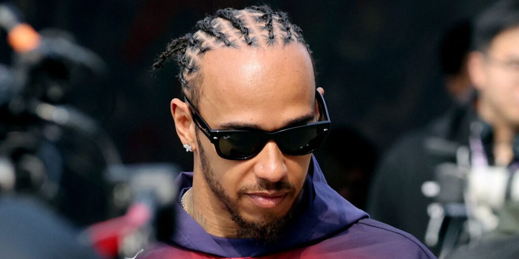 Lewis Hamilton wearing his red Ferrari race suit in the paddock at the Chinese Grand Prix