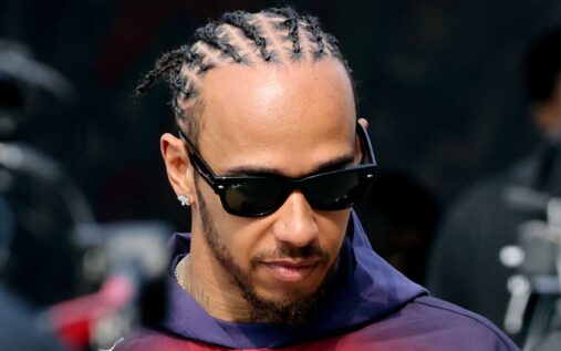 Lewis Hamilton wearing his red Ferrari race suit in the paddock at the Chinese Grand Prix