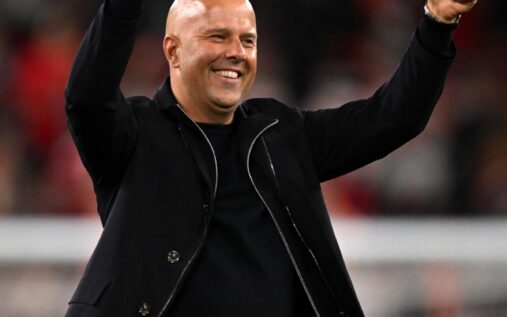 Liverpool manager Arne Slot smiling on the touchline during a Premier League match